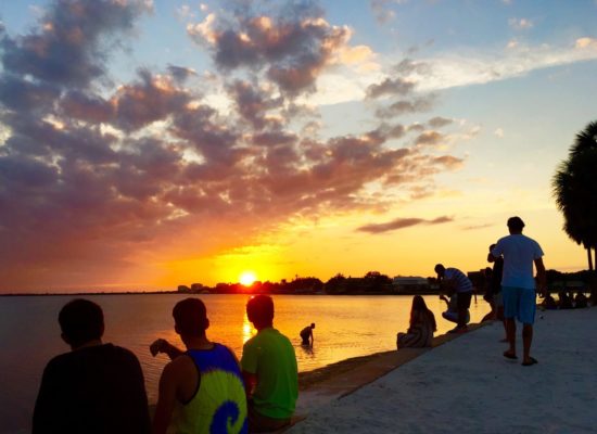 Students sitting on seawall at South Beach watching sunset by Sean Laughlin '17
